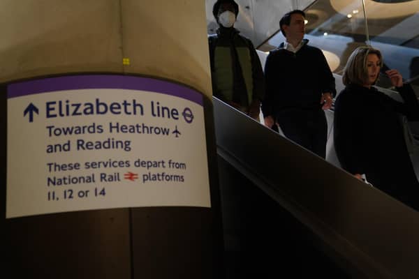 Passengers descend the escalators to the Elizabeth Line platforms at Paddington Station, London, as the new line opens to passengers for the first time.