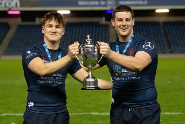 Merchiston's players celebrate with the trophy