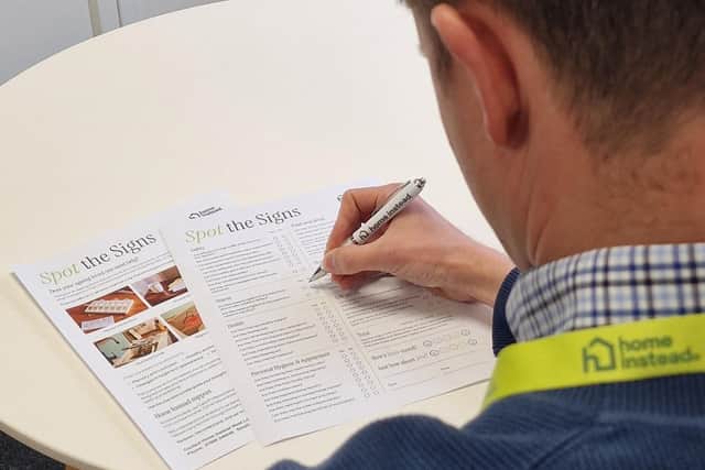 Home Instead staff member completing the 'Spot the Signs' checklist