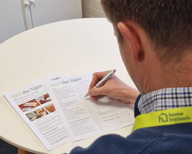 Home Instead staff member completing the 'Spot the Signs' checklist