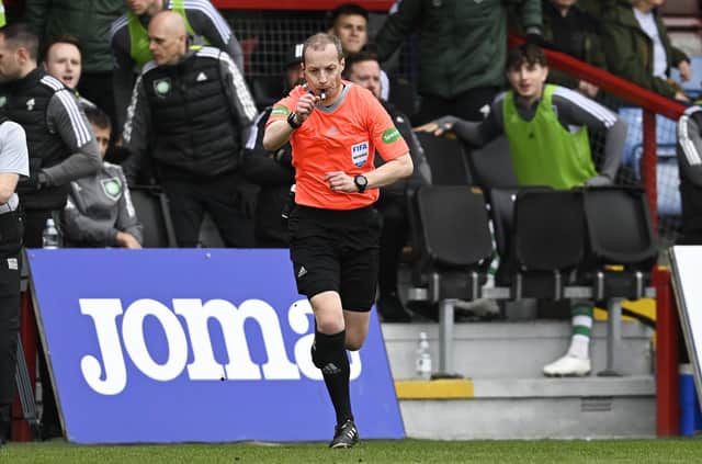 Referee Willie Collum awards a penalty to Celtic after checking the VAR monitor during the match against Ross County.