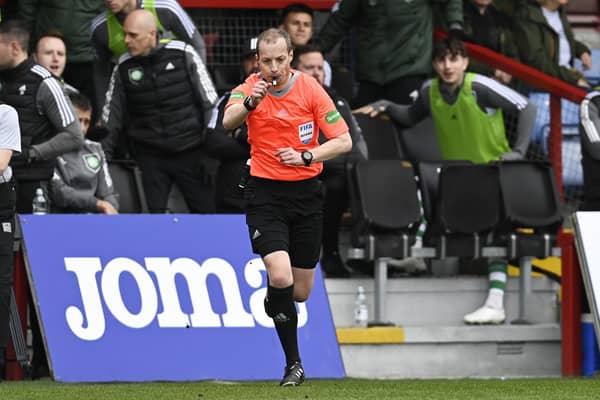 Referee Willie Collum awards a penalty to Celtic after checking the VAR monitor during the match against Ross County.