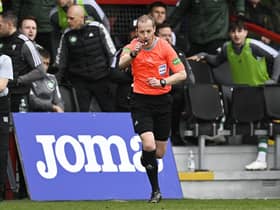Referee Willie Collum awards a penalty to Celtic after checking the VAR monitor during the match against Ross County.