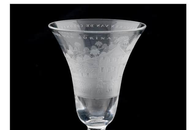 A drinking glass celebrating the wealth of plantation owners in Suriname, a former Dutch colony on the north coast of South America, where there was a large Highland population from the late 17th Century. PIC: Glasgow Museums.