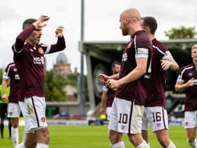 Michael Smith celebrates with his Hearts team-mates after Liam Boyce scored against St Mirren. The Jambos have a 100 per cent record going into the clash with Aberdeen.