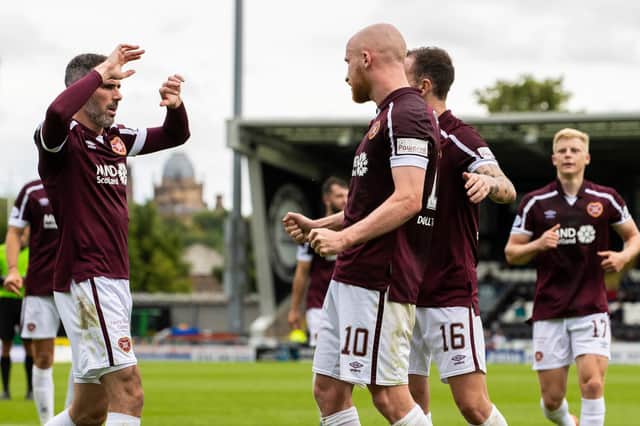 Michael Smith celebrates with his Hearts team-mates after Liam Boyce scored against St Mirren. The Jambos have a 100 per cent record going into the clash with Aberdeen.