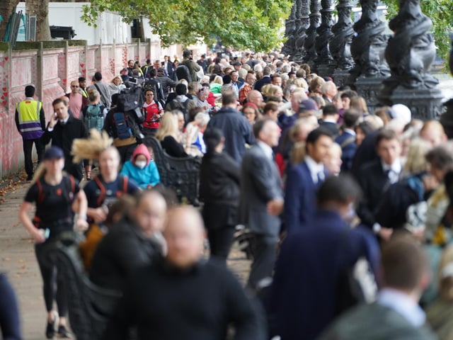 Members of the public join the queue on the South Bank near to Lambeth Bridge