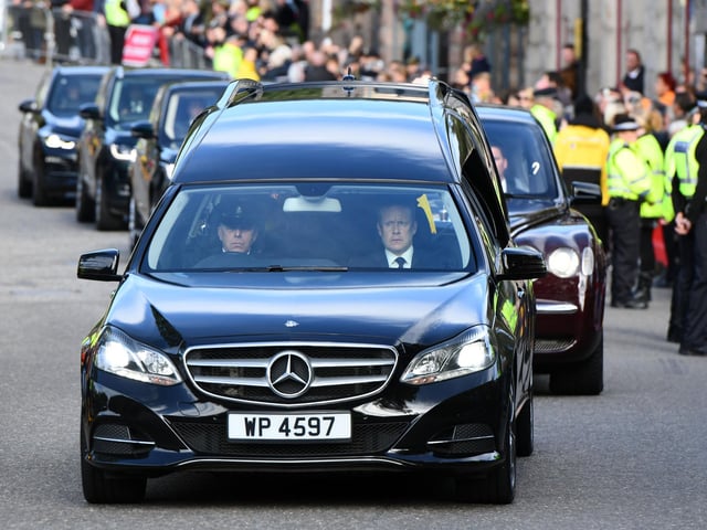 The cortege makes its way through streets lined with people in Balmoral and Ballater at the beginning of a six-hour journey to Edinburgh (Pic: Michael Gillen)