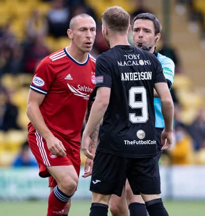 Aberdeen's Scott Brown remonstrates with Livingston's Bruce Anderson.