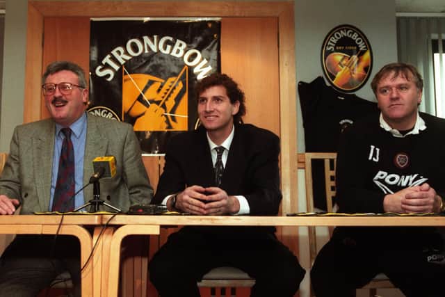 Hearts 'keeper Gilles Rousset (center) is joined by chief executive Chris Robinson and manager Jim Jefferies (right) as he announces his new deal with the club in February 1996
