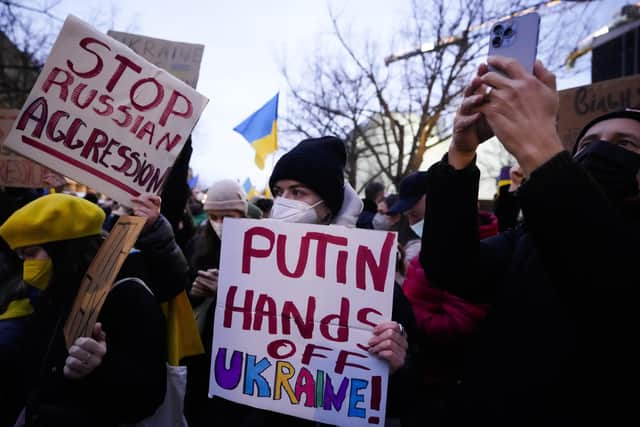 Women show posters in support of the Ukraine as they attend a demonstration along the street near the Russian embassy to protest against the escalation of the tension between Russia and Ukraine in Berlin, Germany. Photo: AP Photo/Markus Schreiber.