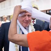 Prime Minister Boris Johnson having a turban placed on his head at Gujarat Bio Technology University, as part of his two day trip to India. Picture date: Thursday April 21, 2022.