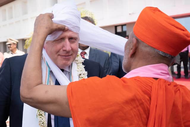 Prime Minister Boris Johnson having a turban placed on his head at Gujarat Bio Technology University, as part of his two day trip to India. Picture date: Thursday April 21, 2022.