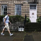 Members of the public walk past a New Town house where the homeowner is facing a council investigation into the colour of the front door. Picture: Jeff J Mitchell/Getty Images