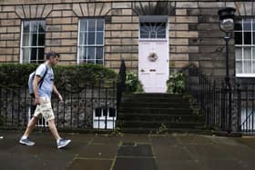 Members of the public walk past a New Town house where the homeowner is facing a council investigation into the colour of the front door. Picture: Jeff J Mitchell/Getty Images