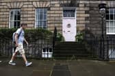 Members of the public walk past a New Town house where the homeowner is facing a council investigation into the colour of the front door. Picture: Jeff J Mitchell/Getty Images