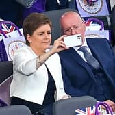 Nicola Sturgeon and her husband and current chief executive officer of the Scottish National Party Peter Murrel take their seats for the Platinum Party at Buckingham Palace