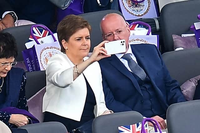 Nicola Sturgeon and her husband and current chief executive officer of the Scottish National Party Peter Murrel take their seats for the Platinum Party at Buckingham Palace