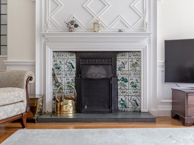 Drawing room fireplace with decorative timber over mantels and original Chinese tiled surrounds.