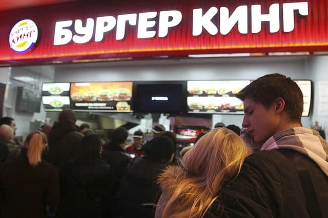 Russian customers wait in line on the opening day of Russia's first Burger King fast food restaurant in Moscow in 2010.