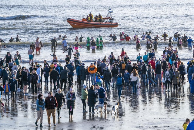 People take part in a Loony Dook New Year's Day dip in the Firth of Forth at Kinghorn in Fife.