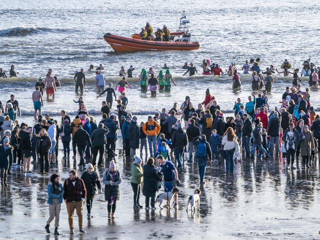 People take part in a Loony Dook New Year's Day dip in the Firth of Forth at Kinghorn in Fife.