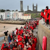 New students at the University of St Andrews take part in the traditional Pier Walk along the harbour walls of St Andrews before the start of the new academic year.