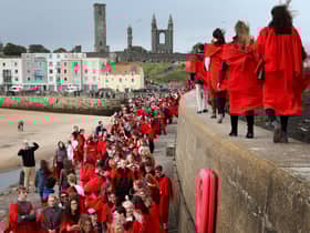New students at the University of St Andrews take part in the traditional Pier Walk along the harbour walls of St Andrews before the start of the new academic year.