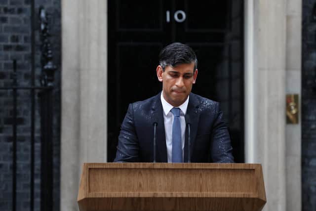 Prime Minister Rishi Sunak, soaked in rain, pauses as he delivers a speech to announce July 4 as the date of the UK's next general election. Picture: AFP via Getty Images