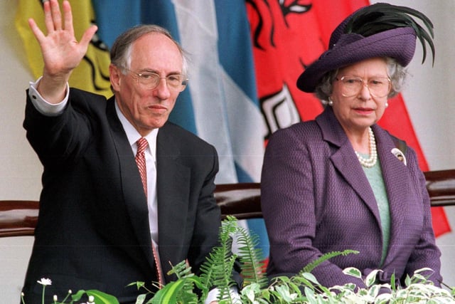 Queen Elizabeth II and Scottish First Minister Donald Dewar watch the parades from the Royal Dias after the opening of the Scottish Parliament in Edinburgh in July 1999.