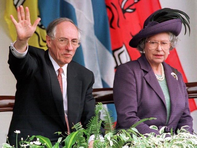Queen Elizabeth II and Scottish First Minister Donald Dewar watch the parades from the Royal Dias after the opening of the Scottish Parliament in Edinburgh in July 1999.
