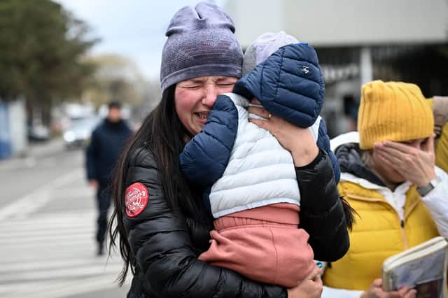 Ukrainian refugees weep after arriving at the Siret border crossing between Romania and Ukraine on Monday (Picture: Daniel Mihailescu/AFP via Getty Images)