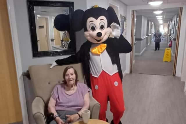Resident with Mickey Mouse at HC-One Scotland’s Merino Court Care Home at Summer Fete
