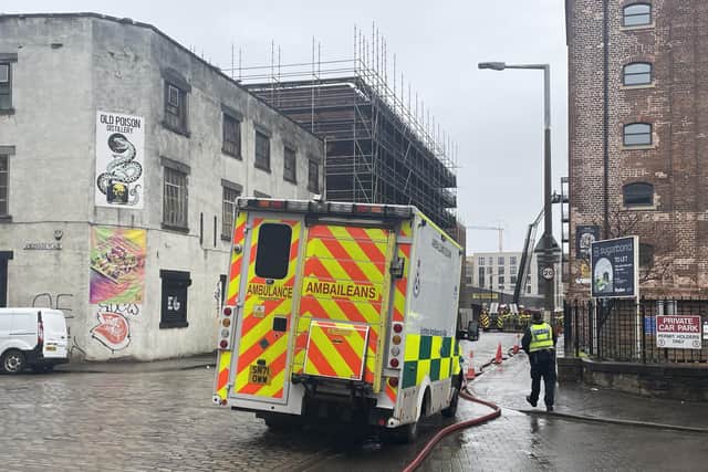 An ambulance sits near the scene of a fire in an Edinburgh block of flats, as firefighters continue to douse the remnants of the blaze. Picture: Ilona Amos