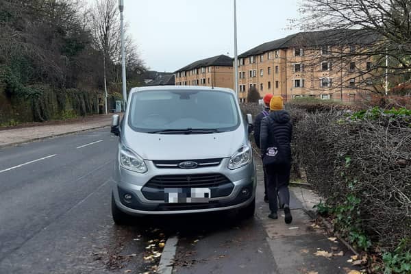Pedestrians squeezing past a van parked on a pavement in Glasgow on Tuesday (Photo by The Scotsman)
