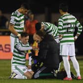 Celtic's  players show concern for Callum McGregor following the faciall injury that has raised concerns of an extended period on the sidelines for the player. (Photo by Craig Foy / SNS Group)