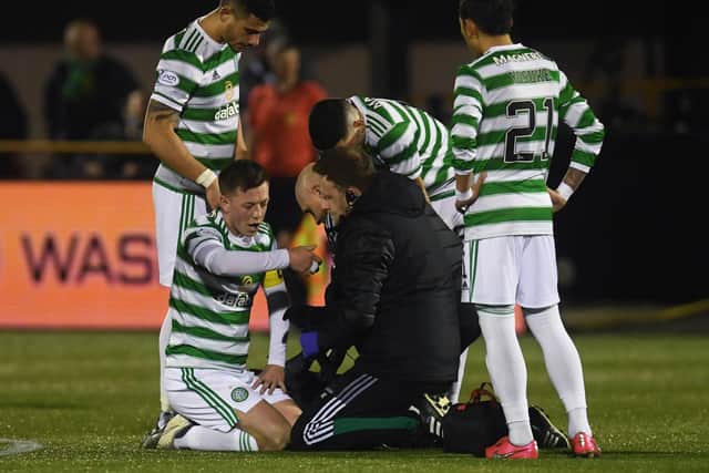 Celtic's  players show concern for Callum McGregor following the faciall injury that has raised concerns of an extended period on the sidelines for the player. (Photo by Craig Foy / SNS Group)
