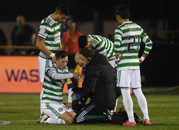 Celtic's  players show concern for Callum McGregor following the faciall injury that has raised concerns of an extended period on the sidelines for the player. (Photo by Craig Foy / SNS Group)