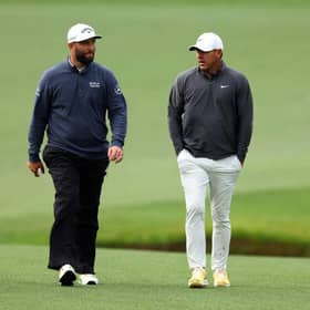 Jon Rahm and Brooks Koepka walk up the 13th fairway during the continuation of the weather-delayed third round of the 2023 Masters at Augusta National Golf Club. Picture: Andrew Redington/Getty Images.