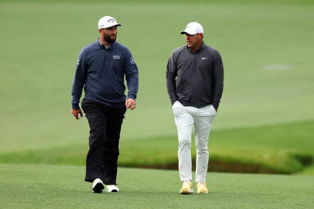 Jon Rahm and Brooks Koepka walk up the 13th fairway during the continuation of the weather-delayed third round of the 2023 Masters at Augusta National Golf Club. Picture: Andrew Redington/Getty Images.