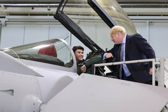 Boris Johnson speaks to a pilot in a Typhoon fighter jet at RAF Lossiemouth during a visit last year (Picture: Andrew Milligan/pool/AFP via Getty Images)