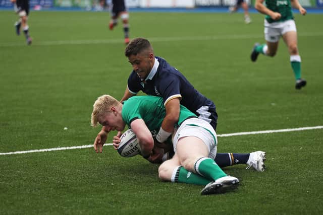 Ireland's Jamie Osborne is tackled by Scotland's Ollie Melville . Picture: Bradley Collyer/PA Wire