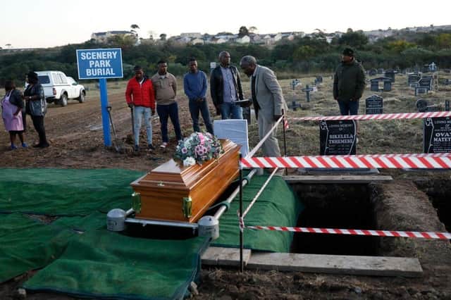 People stand near the coffin of Thembinkosi Silwane during his burial at Heaven Hills Cemetry in East London after he and 20 others, mostly teens, died in unclear circumstances at a township tavern last month, in an incident that shocked South Africa.