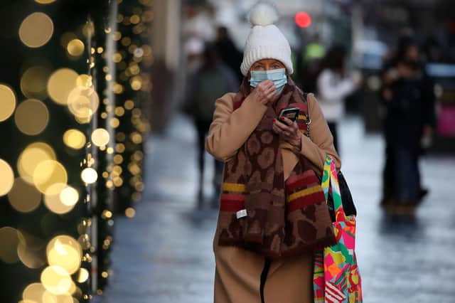 A member of the public wearing a face covering shopping on Buchanan Street in Glasgow