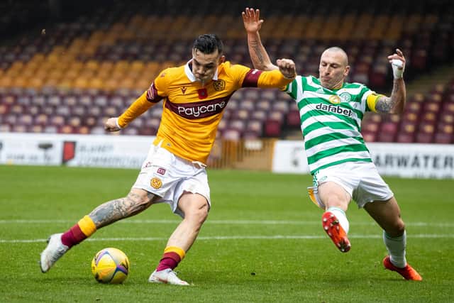 Motherwell's Tony Watt takes a shot on goal under challenge from Celtic captain Scott Brown. (Photo by Craig Williamson / SNS Group)