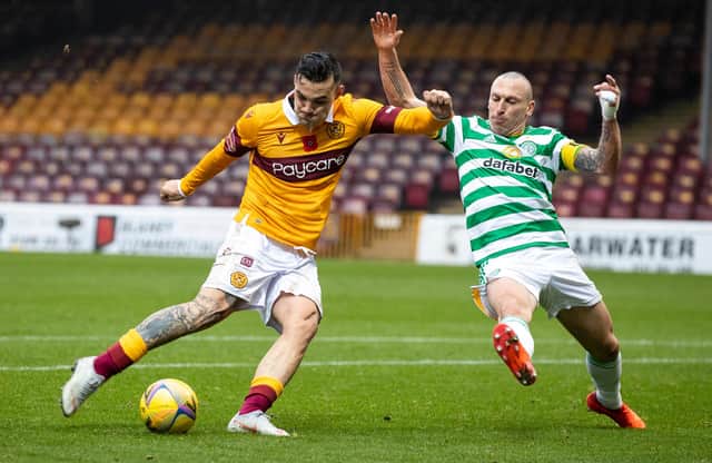 Motherwell's Tony Watt takes a shot on goal under challenge from Celtic captain Scott Brown. (Photo by Craig Williamson / SNS Group)