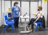 People aged over 50 who did not receive their second Covid vaccination until the summer, like the First Minister, pictured above, may have to wait until the new year to receive their flu jag.