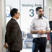 Humza Yousaf (centre) alongside Consultant Orthopedic Surgeon Andy Ballantyne (right) as they speak to a member of staff during a visit to visit the National Treatment Centre at Victoria Hospital in Kirkcaldy, Fife. Photo: Lesley Martin /PA Wire