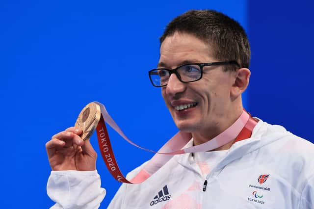 Scott Quin poses with his bronze medal in the men's 100m Breaststroke - SB14 final.