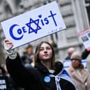 A protester holds reading "Coexist" during a demonstration in central London on Sunday to protest against antisemitism. Photo by JUSTIN TALLIS / AFP